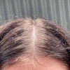A woman hair with lighter roots.