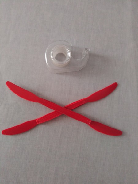 Two plastic spreaders placed in an "x"