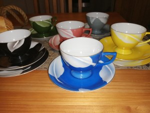 A collection of decorative teacups in different colors.