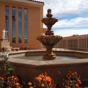 A fountain with orange flowers.
