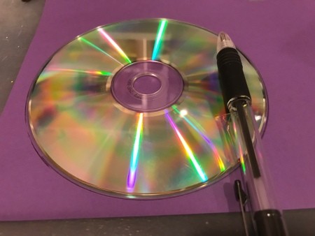 Using a CD to trace a circle on paper.