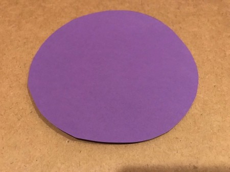 A circle cut out of purple paper.