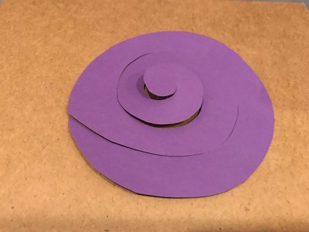 A spiral cut out of purple paper.