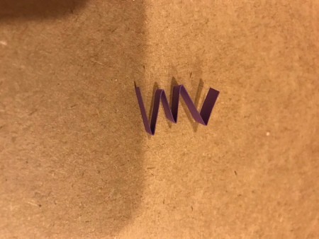 Folding the purple strips in a zig zag pattern.