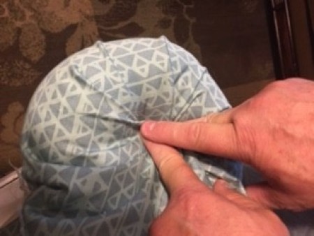 Reupholstering the arm of a chaise lounge.