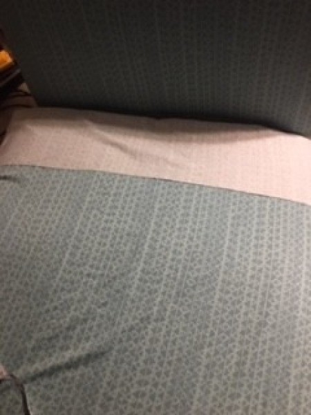 Reupholstering a chaise lounge.