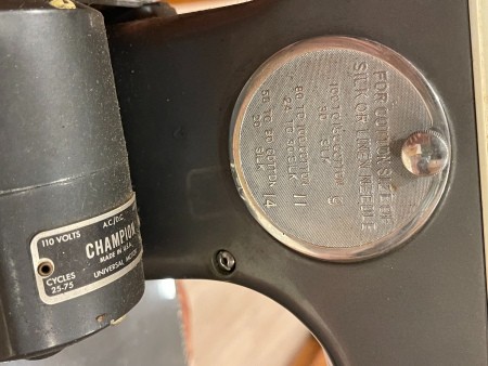 A metal label on a sewing machine.