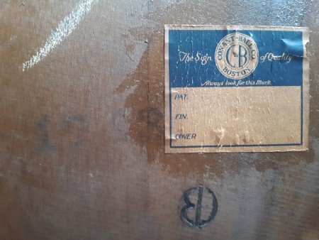The label on the bottom of a wooden chair.