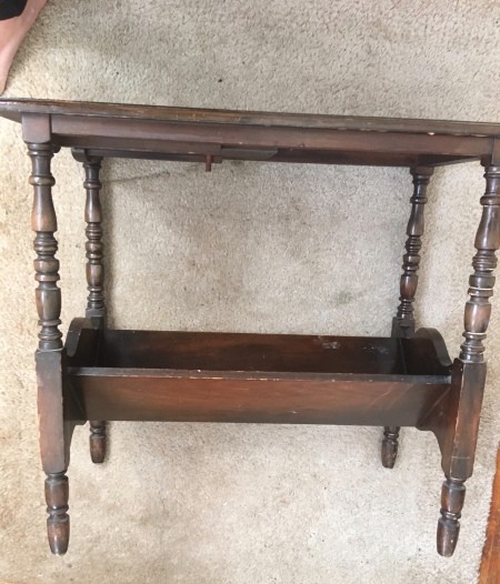 A side table with a bottom tray that pulls out.