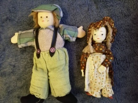 Two dolls dressed in an old fashioned style.