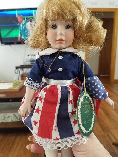 A doll with red, white and blue clothing.