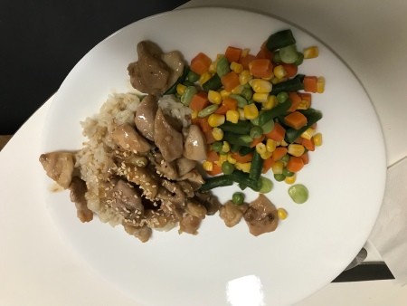 A plate of honey garlic chicken with veggies.