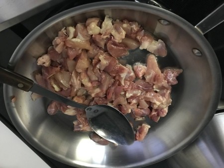 Cooking chicken in a wok.