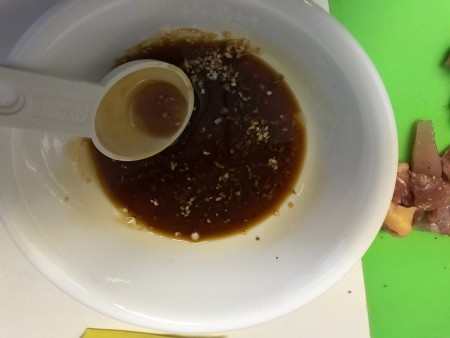 Combining ingredients to make a sauce.