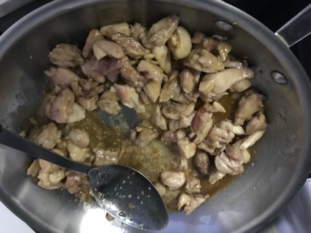 Cooking honey garlic chicken in a wok.
