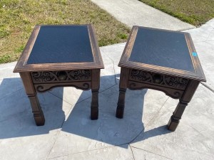 A pair of leather topped tables.
