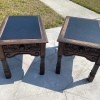 A pair of leather topped tables.