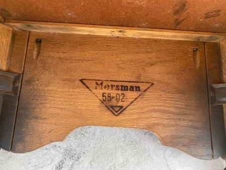 The Mersman marking on the bottom of a side table.