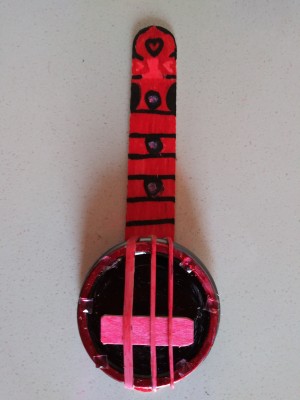 A mini banjo made from recycled materials.