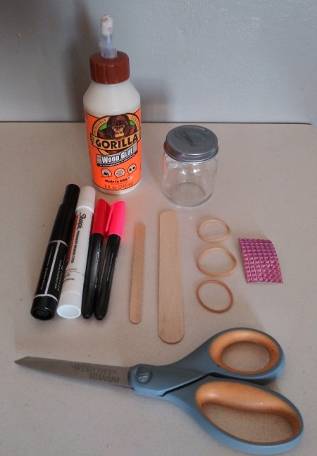 Supplies for making a mini love banjo.