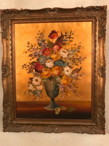An old fashioned painting of flowers.
