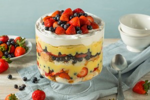 A trifle dessert with whipped cream, fruit and angel food cake.