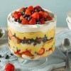 A trifle dessert with whipped cream, fruit and angel food cake.