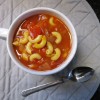 A bowl of tomato macaroni soup.