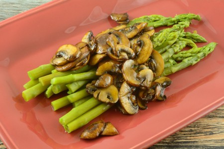 Asparagus with mushrooms on a plate.