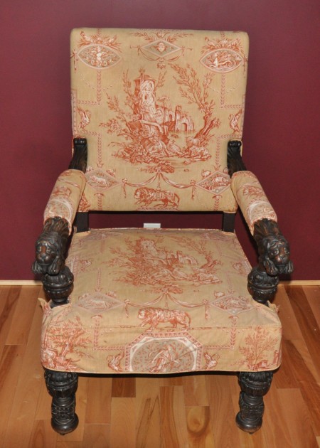 An armchair with ornate fabric.