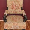 An armchair with ornate fabric.