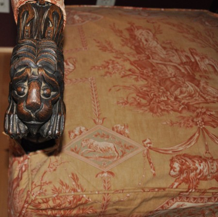 An armchair with ornate fabric.