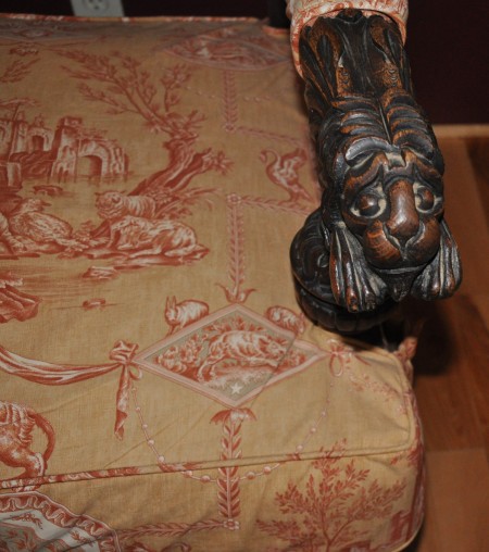 An armchair with ornate fabric.