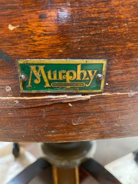 The Murphy logo on the side of a wooden chair.
