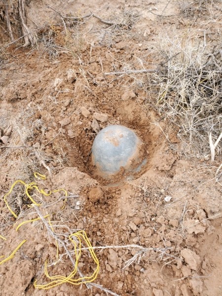 A piece of metal found in the dirt.