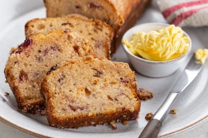 A loaf of quick bread with orange and cranberries.
