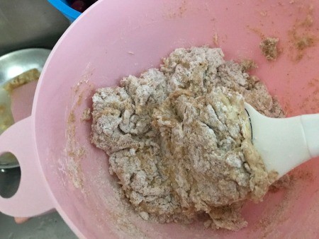 Mixing muffin batter in a bowl.