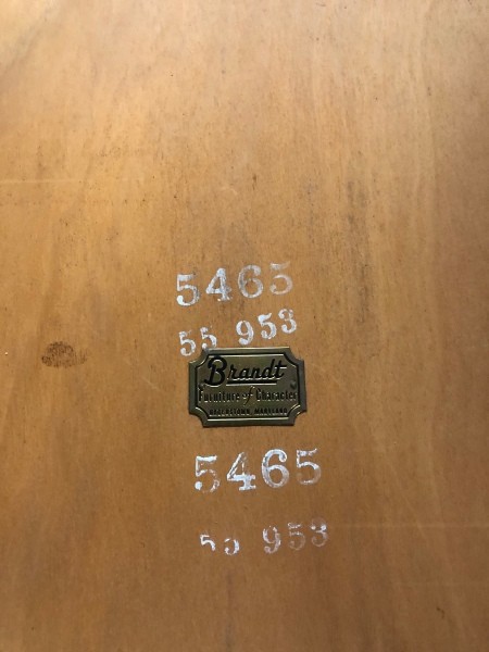 A Brandt label on the bottom of a table.