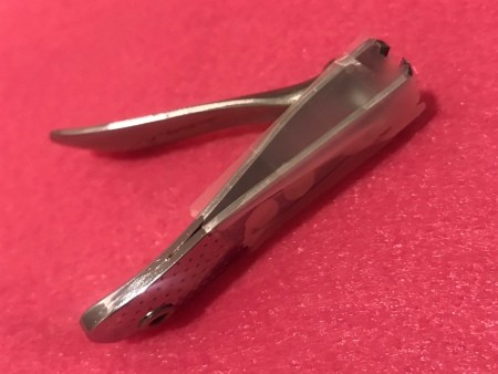 A pair of nail clippers with tape on the side.