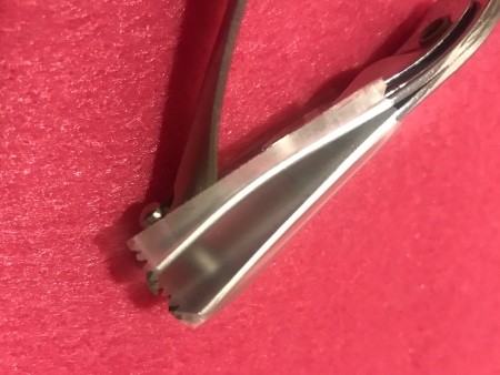 A pair of nail clippers with tape on the side.