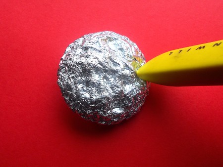 Making Shank Buttons the Cheap Way Using Concrete - press foil in to button design with eraser