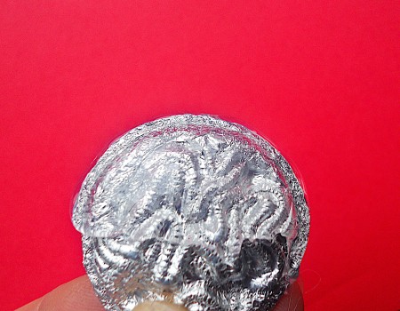 Making Shank Buttons the Cheap Way Using Concrete - closeup of foil over button ready to apply glue