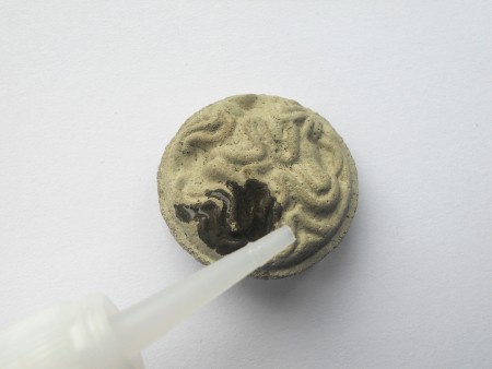 Making Shank Buttons the Cheap Way Using Concrete - coat top with instant glue