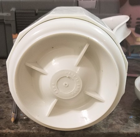 A coffee carafe that has been taken apart.