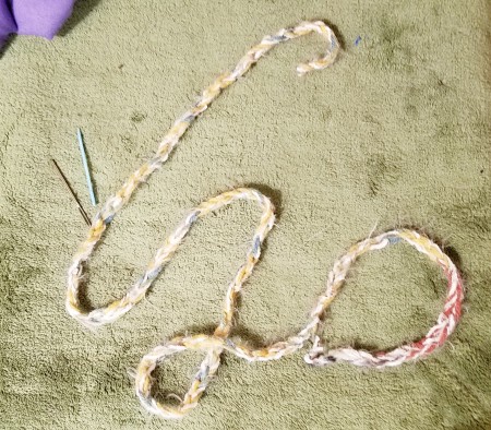 A crochet chain on the floor.
