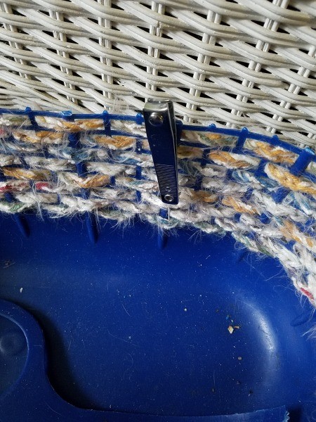 Using nail clippers on the crocheted plastic basket.