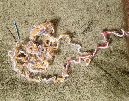 Colorful yarn on the floor.