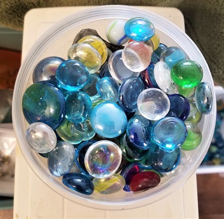 A container of glass marbles.