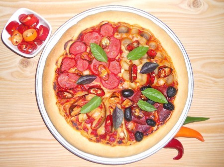 The baked pizza with 4 quadrants of toppings.