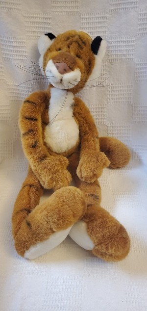 A stuffed tiger with hands and feet.